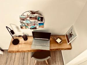 a desk with a laptop computer on top of it at Casa Armonía in Morro del Jable