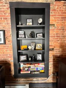 a black book shelf in a brick wall at Historic, Stylish Getaway 2 blocks from Waterfront in Bellefonte