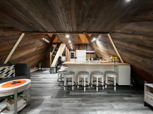 a kitchen with a counter and stools in a room at Serendib by St Peters Bay in Saint Peters