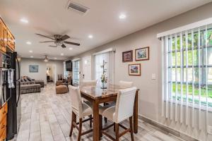 a dining room with a table and white chairs at Bay Breeze Retreat plus 15 minutes from central TPA in Tampa
