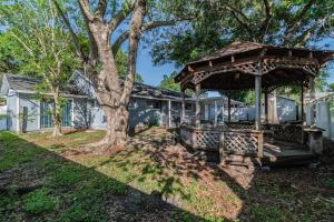 a house with a gazebo and a tree at Bay Breeze Retreat plus 15 minutes from central TPA in Tampa