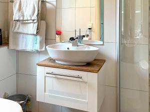a bathroom with a white sink and a shower at 5 person holiday home in ULRICEHAMN-By Traum in Ulricehamn +18 photos