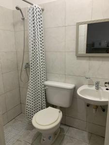 a bathroom with a toilet and a sink at Zona Sur Apart in Salta