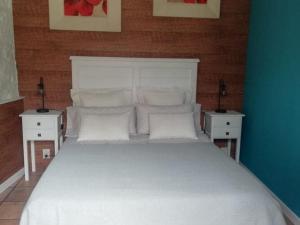 a bedroom with a white bed with two night stands at Vibrant holiday home in Villanueva with terrace in Villanueva