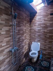 a bathroom with a shower with a toilet in it at Pondok Biu in Denpasar