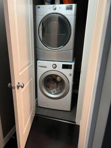 a washer and dryer in a small room at Lovely 2 bedroom 2 bathroom plus den in Calgary