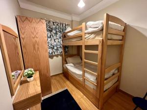 a small room with two bunk beds and a desk at Alexander House in Alexandria