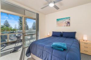 a bedroom with a bed and a balcony at Crystal Waters 2 2 Munster Street in Port Macquarie