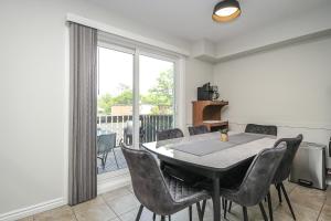 a dining room with a table and chairs and a window at Adrians Wasaga Beach in Wasaga Beach