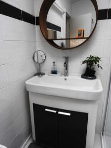 a bathroom with a white sink and a mirror at Longhorn Ranch Apartments in Orbost