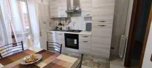 a kitchen with a table and a stove top oven at Casa OASI in Formia