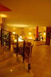 a room with a staircase with a table and chairs at El Mosaico Del Sol in Lampedusa