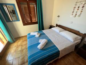 a bedroom with a bed with towels on it at Katerina Charming Place in Agios Nikolaos