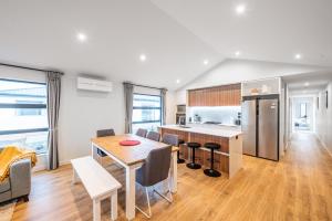 a kitchen and dining room with a table and chairs at Starry Lodge in Lake Tekapo