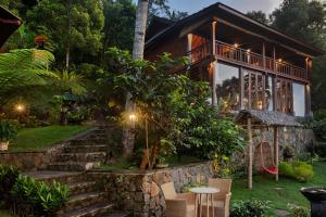 a house with a stone staircase leading up to it at Loids Villa Eco Lodge Lempuyang in Karangasem