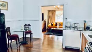 a kitchen and a living room with a table at Parker st in Cootamundra
