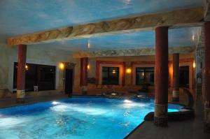 a large indoor swimming pool in a hotel at Hotel Oleńka in Szydłowiec