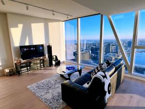 a living room with a couch and a large window at WSP luxury 2b2b apartment in CBD with free parking in Melbourne
