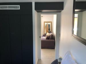 a hallway with a living room with a couch at La Verda in Bonifacio