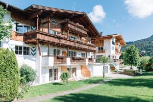 a large apartment building with balconies and a yard at Landhaus Sammer in Tannheim