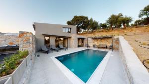 a villa with a swimming pool and a house at DAELIA Villas in Plomari