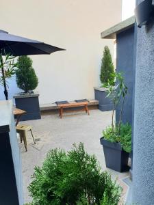 a patio with potted plants and a wooden bench at Room eleven in Veliko Tŭrnovo