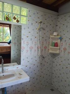 a bathroom with a sink and a shower in it at Ban Tidlay - SHA in Ko Yao Noi