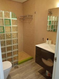 a bathroom with a shower and a toilet and a sink at La Torre Golf Resort, Mero, Torre-Pacheco, Murcia in Murcia