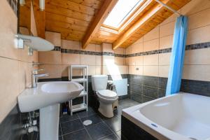 a bathroom with a sink and a toilet and a tub at Dinos Apartments in Vasiliki