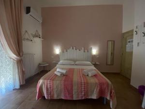 Ένα ή περισσότερα κρεβάτια σε δωμάτιο στο Il Casale del Nonno Bed&Breakfast