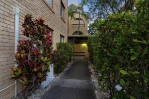 a walkway in front of a building with plants at El Olivia on Genoa Family & Pet Friendly in Gold Coast
