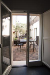 a sliding glass door leading to a patio with a table at BB LETTERARIO in Ravenna