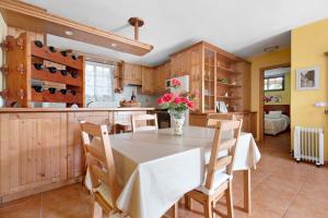 a kitchen with a table with a vase of flowers on it at Apartamento las Viñas 1 in Icod de los Vinos