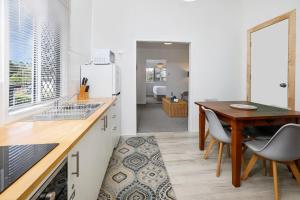 a kitchen with a wooden table and a dining room at A Touch of the Bahamas on McKenzie MK3 in Cairns