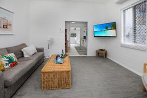 ein Wohnzimmer mit einem Sofa und einem Couchtisch in der Unterkunft A Touch of the Bahamas on McKenzie MK3 in Cairns
