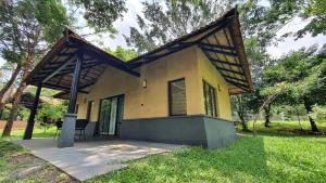 a small house with a roof on top of it at Klov Resort & Spa in Wayanad