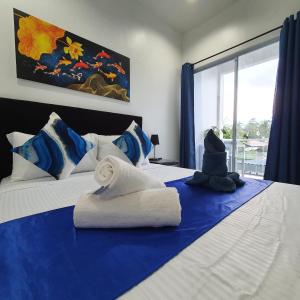a blue and white bed with a towel on it at Sapphire Boutique Resort in Panglao +74 photos
