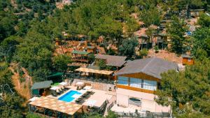 an aerial view of a house with a swimming pool at Tree Houses Hotel in Fethiye