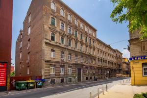 a large brick building on the side of a street at Lux Apartments in Rijeka