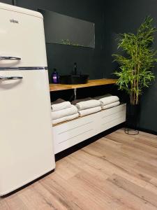 a kitchen with a white refrigerator and a sink at Ofek's place - Midtown TLV in Tel Aviv
