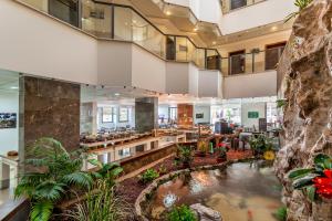 a hotel lobby with a koi pond at Aviv Holiday Flat in Tiberias