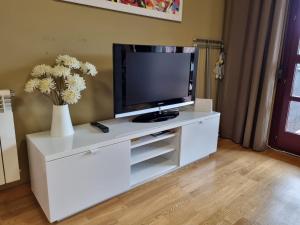 a white entertainment center with a flat screen tv on it at 13A01 Apartamento con garaje y terraza in Ribadesella