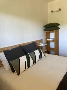 a bedroom with a bed with black and white pillows at Apartament Orbis La molina in La Molina