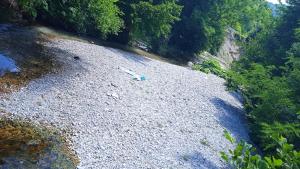 an overhead view of a river with rocks and trees at Via Dinarica GuestHouse in Jablanica