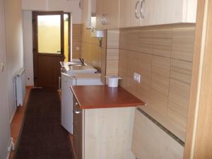 a small bathroom with a sink and a washing machine at Pensiunea Mimi in Mediaş