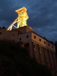 a tower on top of a building at night at Apartman u Štoly in Jáchymov