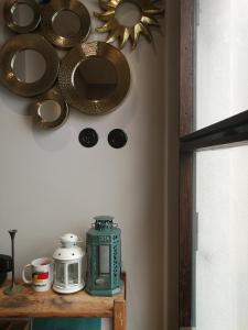a shelf with plates and a clock on a wall at Al Sale in Cagliari +51 photos