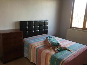 a bedroom with a bed with a purse on it at müstakil köy evi in Trabzon