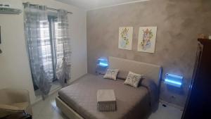 a bedroom with a bed with two pillows on it at La casa del custode in Caccamo