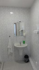 a white bathroom with a sink and a mirror at Penzion U Hradeb in Znojmo